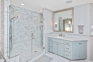 white marble finish master bathroom | light blue vanity | walk in double shower | fbc remodel