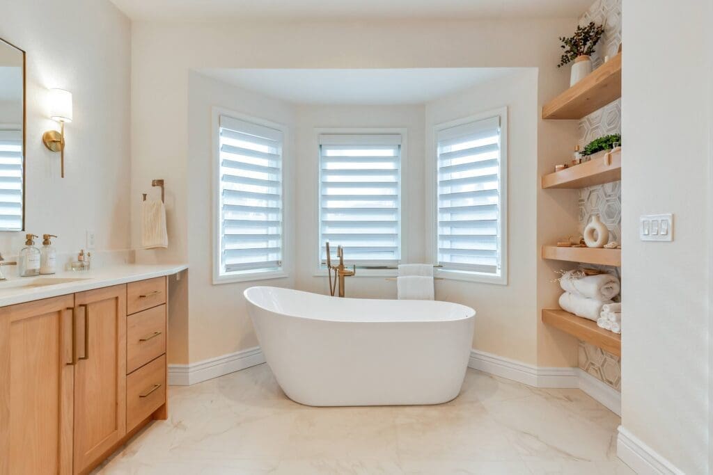 Spa-like bathroom with freestanding tub and open wood shelving