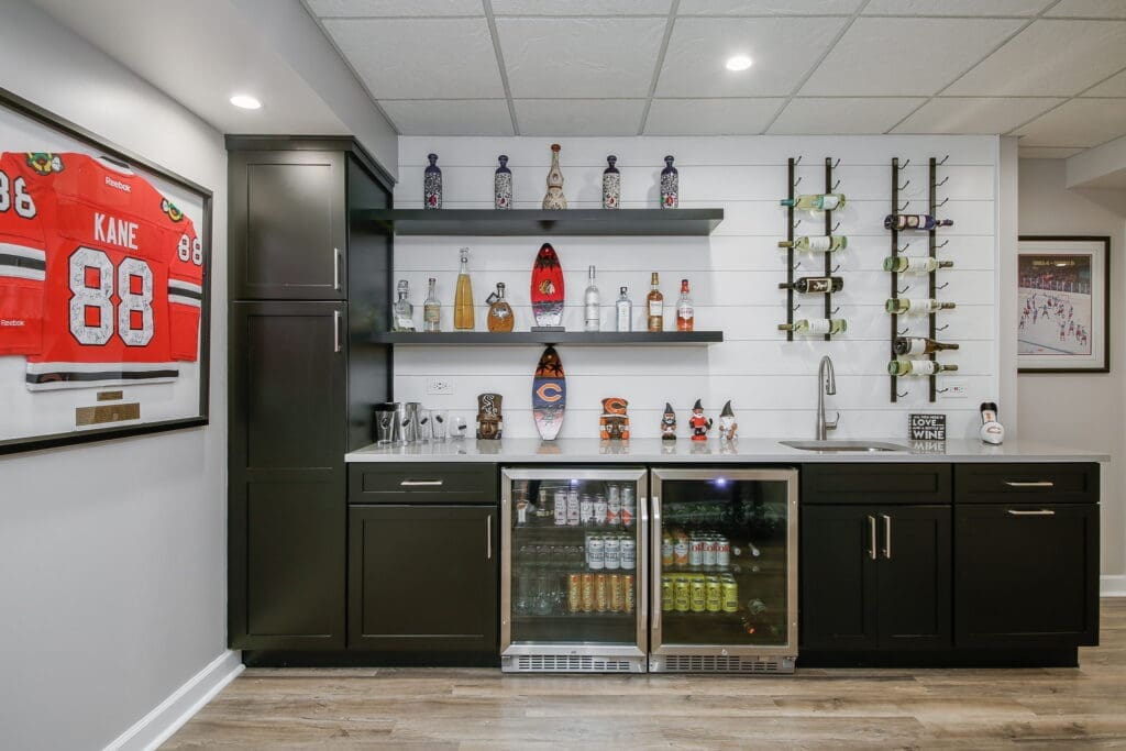 Custom basement bar with sports memorabilia in Clarendon Hills remodel