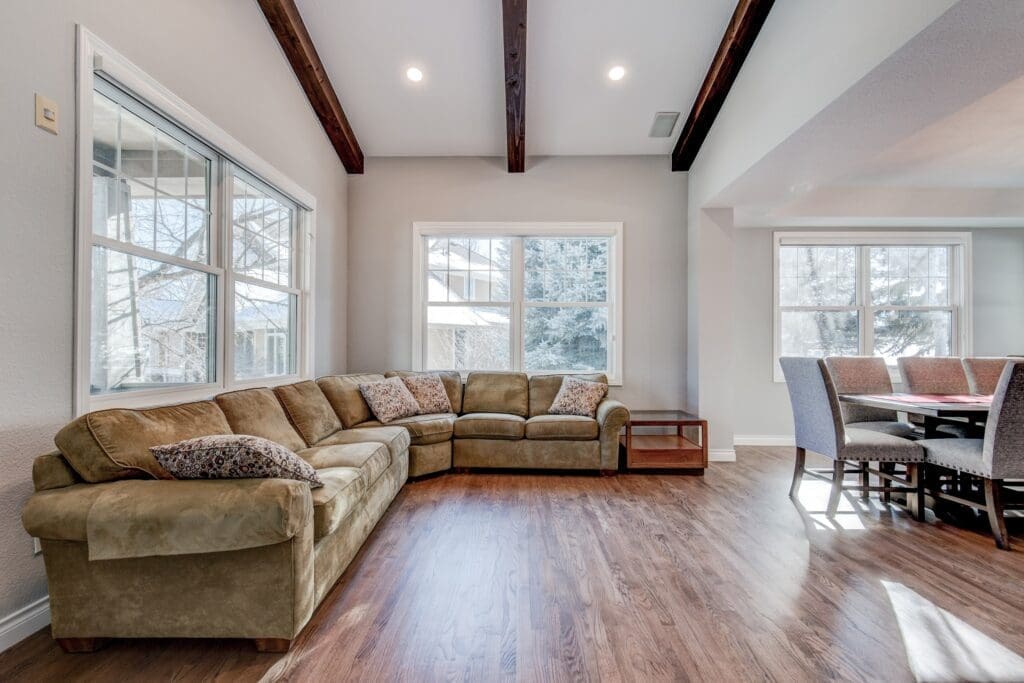 Living room with vaulted ceiling, exposed beams, and sectional sofa