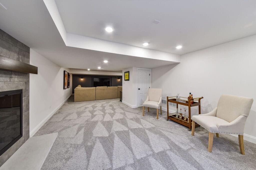 Spacious basement with lounge seating and modern fireplace