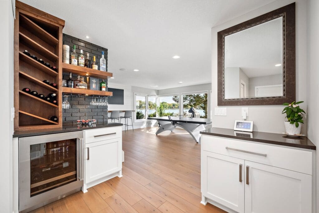 Basement bar and entertainment area with black brick, lake views, and ping pong table