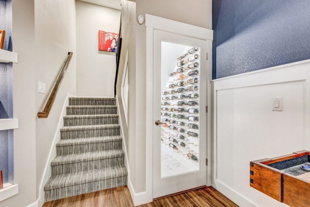 Under-stair wine cellar with glass door and horizontal bottle display