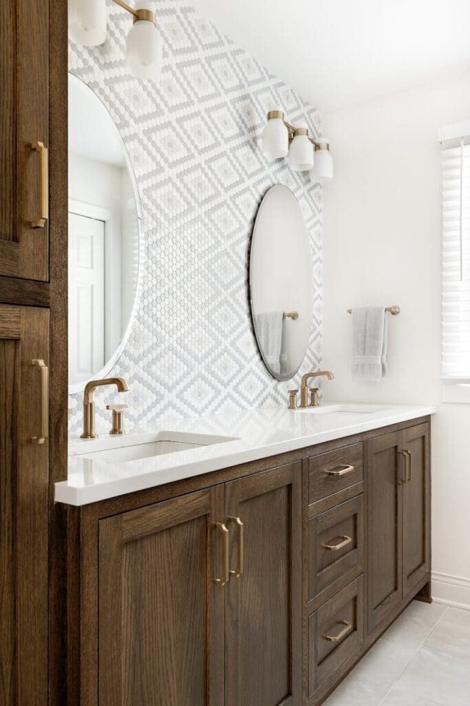 Double vanity with circular mirrors and patterned backsplash