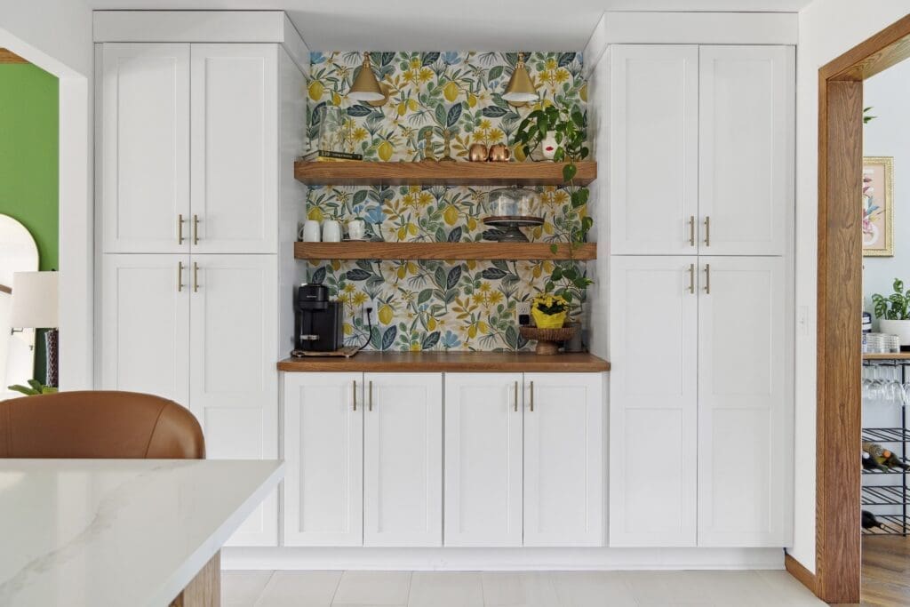 Built-in pantry with floral wallpaper and open wood shelves
