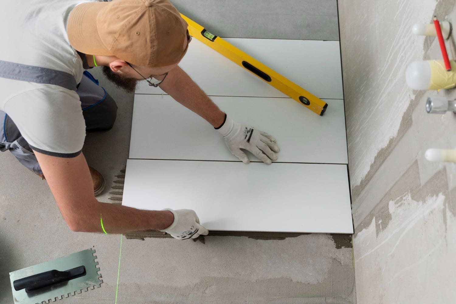 A contractor installing tiles for small bathroom ideas