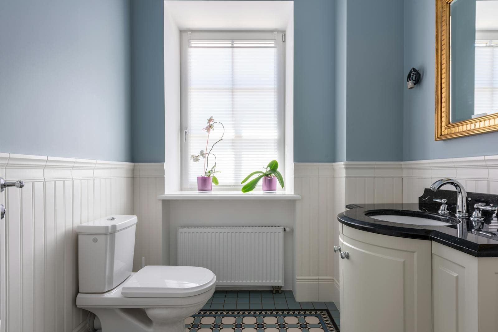 A small bathroom with natural light coming from the window.