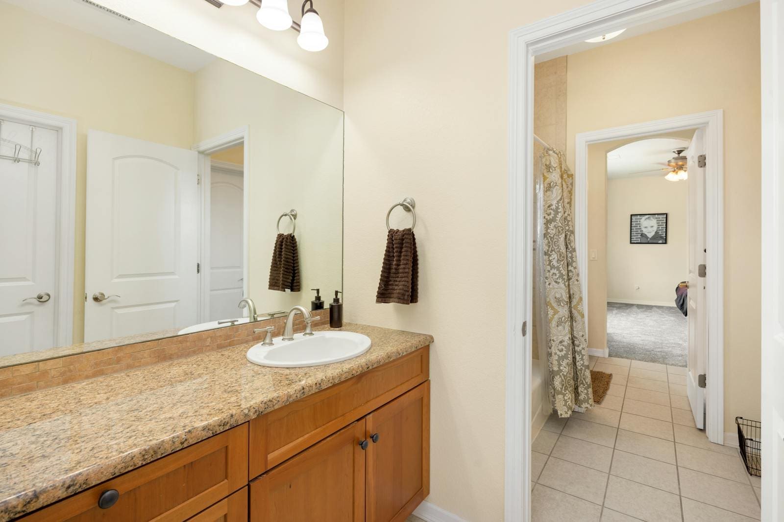 Width-wide bathroom mirror in a smaller bathroom area.